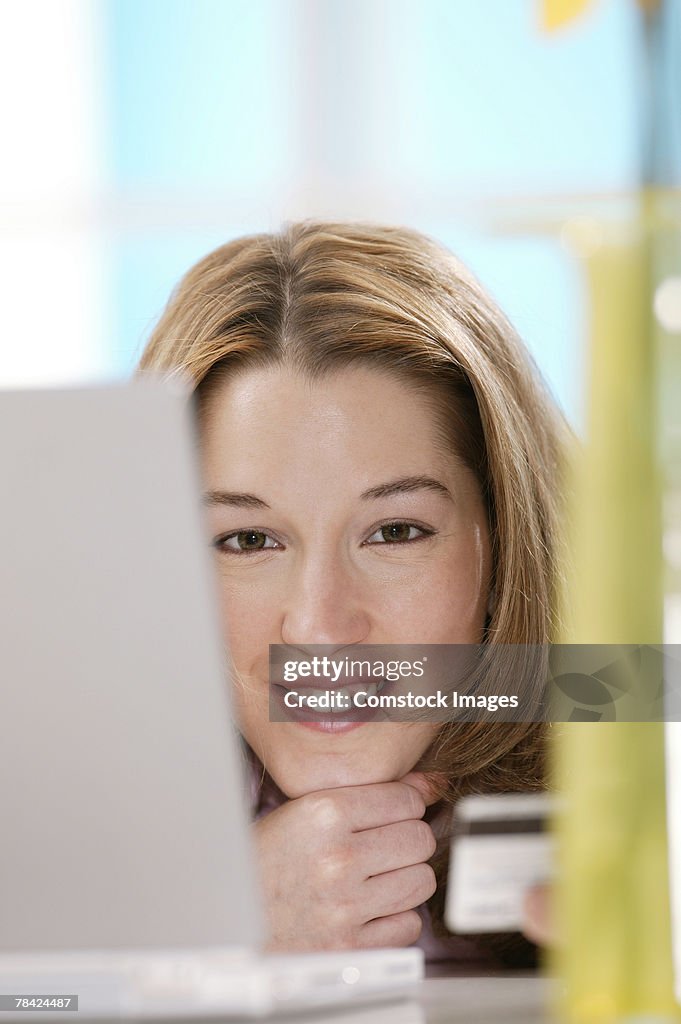 Woman with credit card and laptop computer
