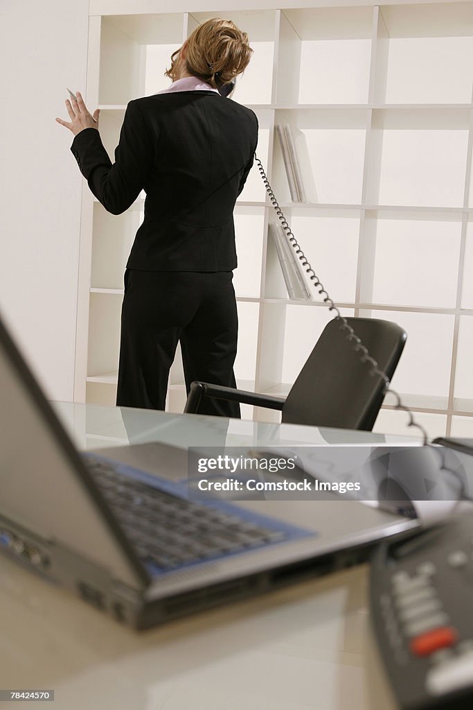 Businesswoman talking on telephone in office