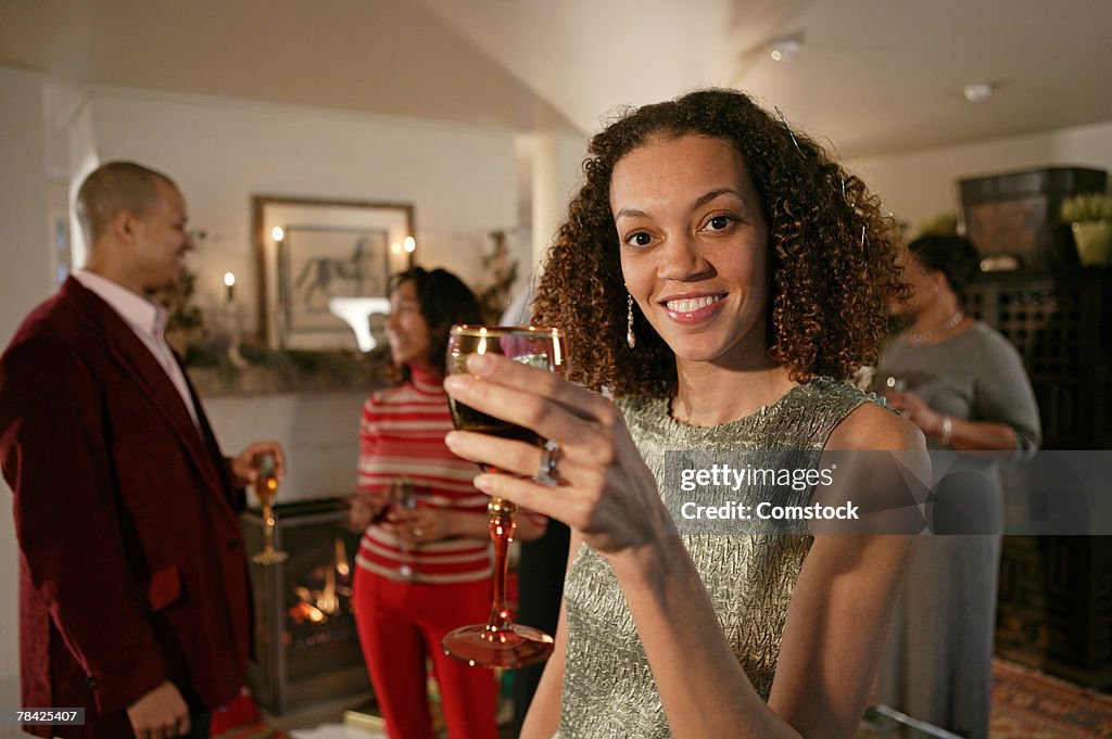 Woman holding a drink at a cocktail party