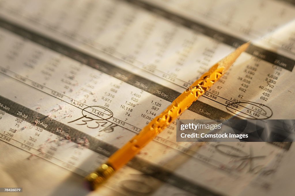 Chewed pencil atop accounting figures