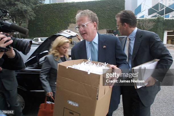 William Lerach carries a box of shredded documents January 22, 2002 into the Federal Court House in Houston, Texas. The documents, from Enron, were...