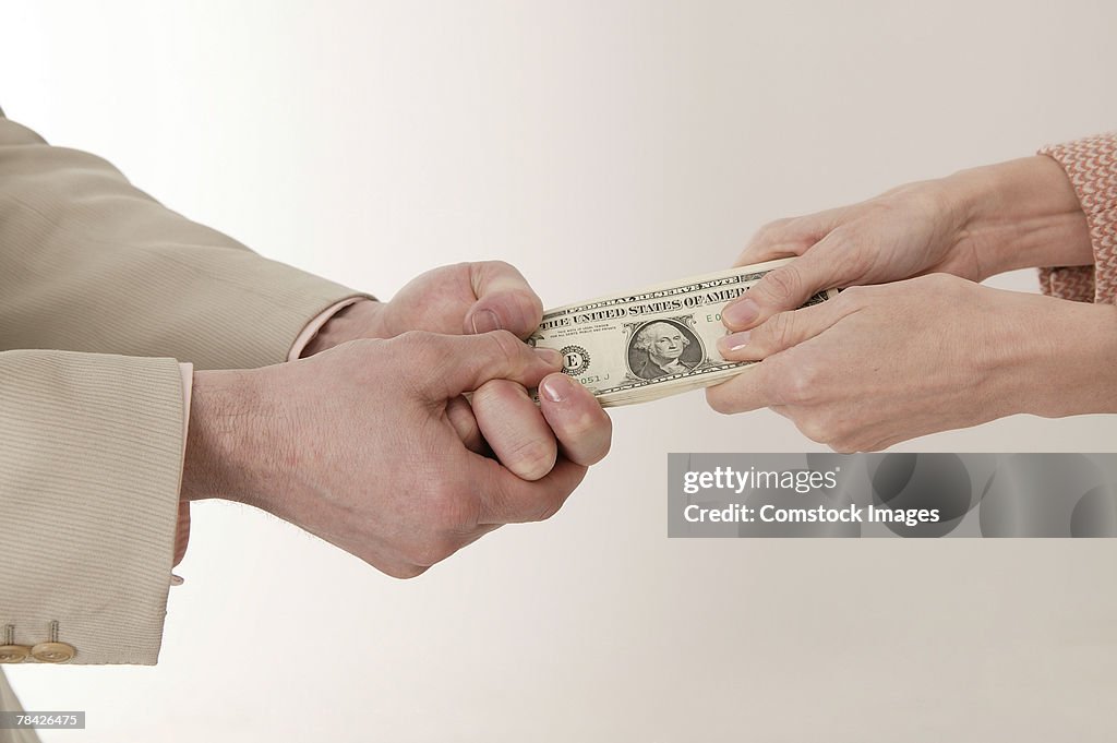 Man and woman fighting for money