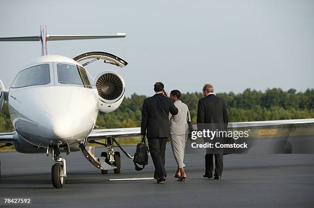 businesspeople boarding private plane - boarding plane stock-fotos und bilder