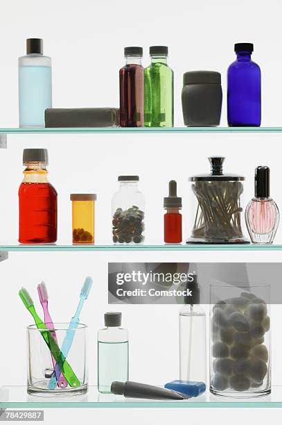 bottles inside medicine cabinet - armoire de toilette photos et images de collection