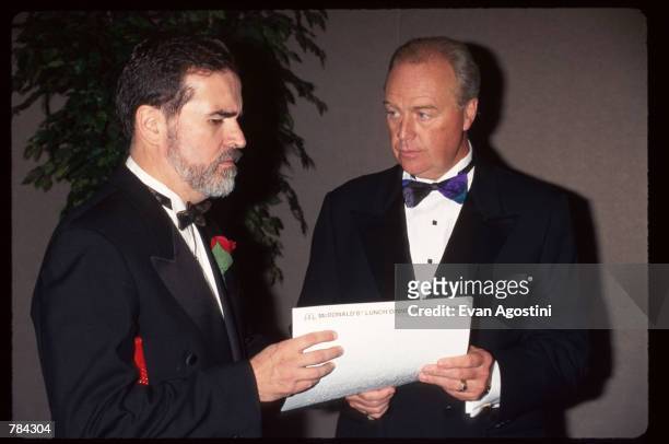 Executive Director of the American Foundation for the Blind Carl Augusto and Michael Quinlan hold a piece of paper June 25, 1996 in New York City....