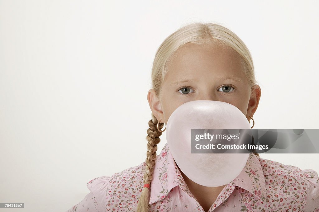 Girl blowing bubble with gum