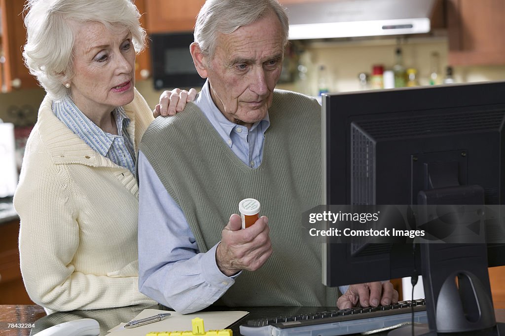 Couple with computer and pill bottle