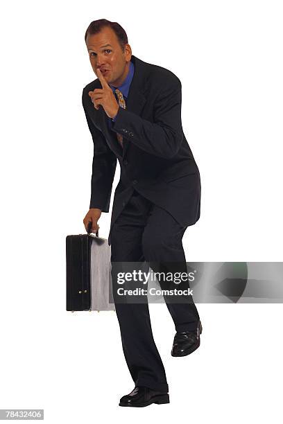 businessman with briefcase sneaking around - tiptoe stock pictures, royalty-free photos & images