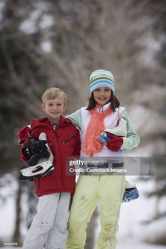 Brother and sister with ice skates