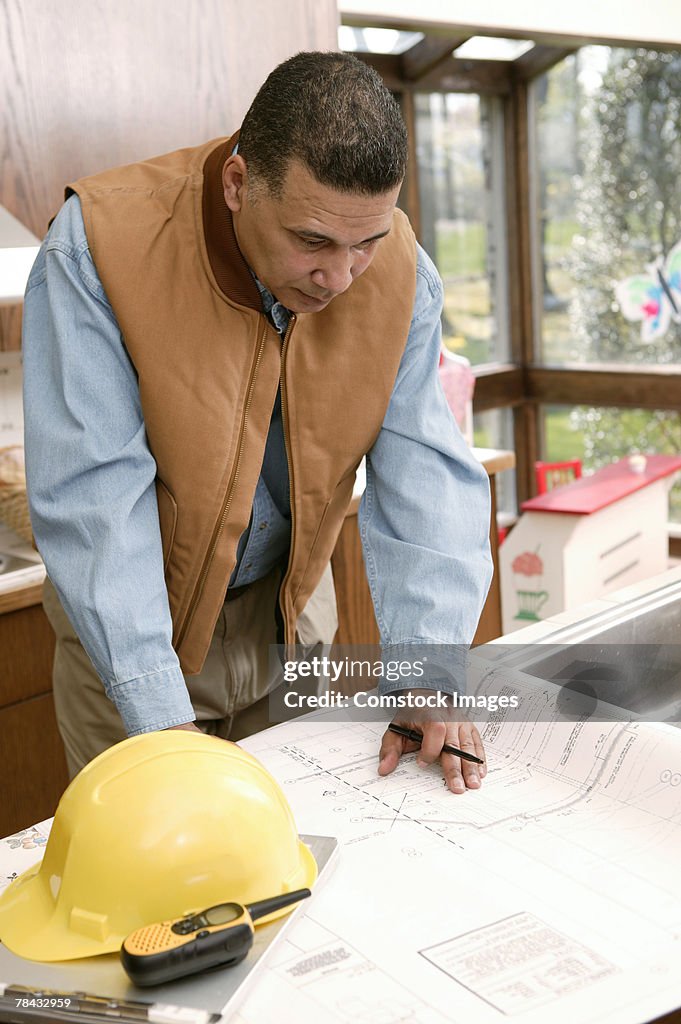 Architect looking at blueprints