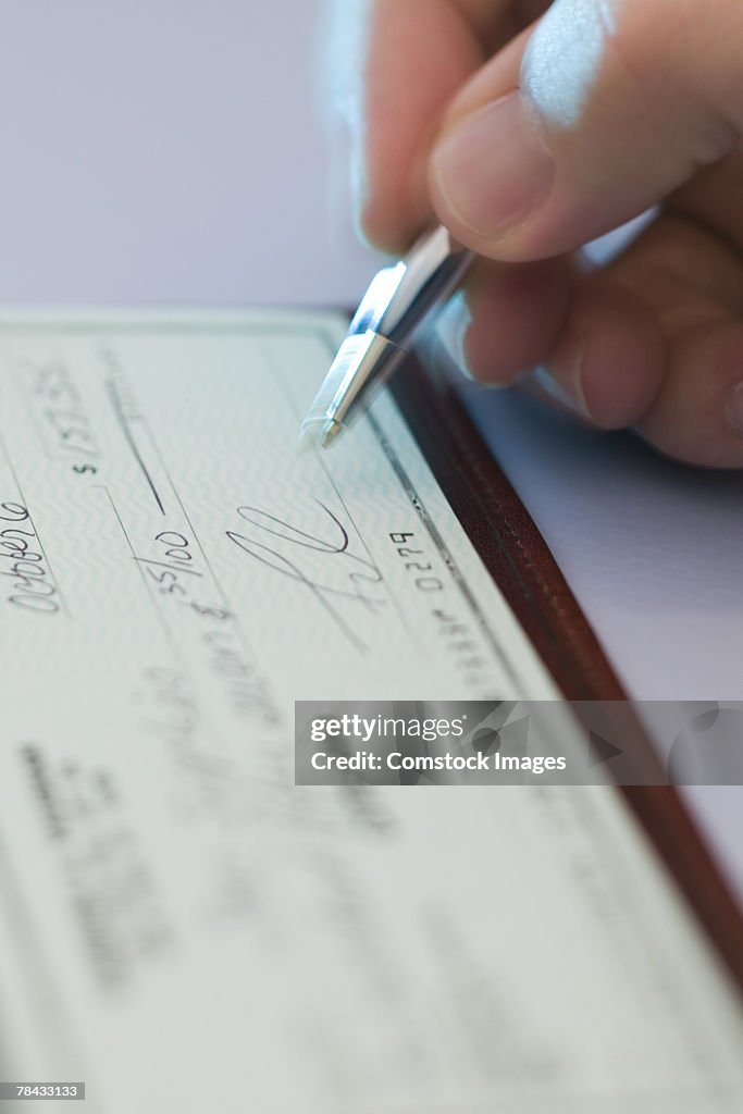 Person Signing Check High-Res Stock Photo - Getty Images