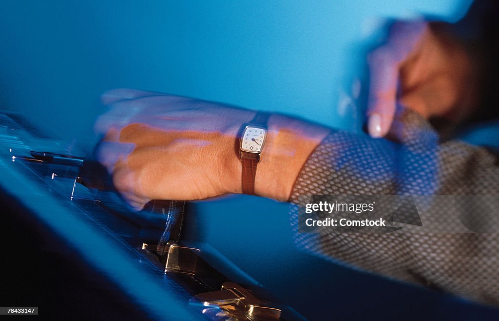 Woman carrying briefcase and checking watch