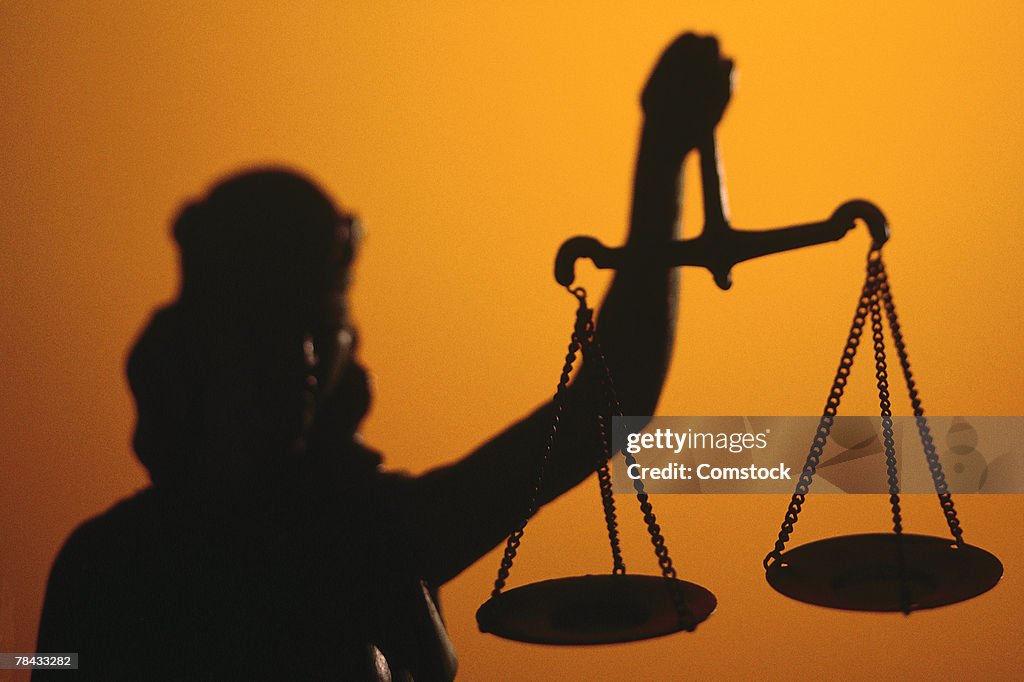 Silhouette of scales of Lady Justice holding scales