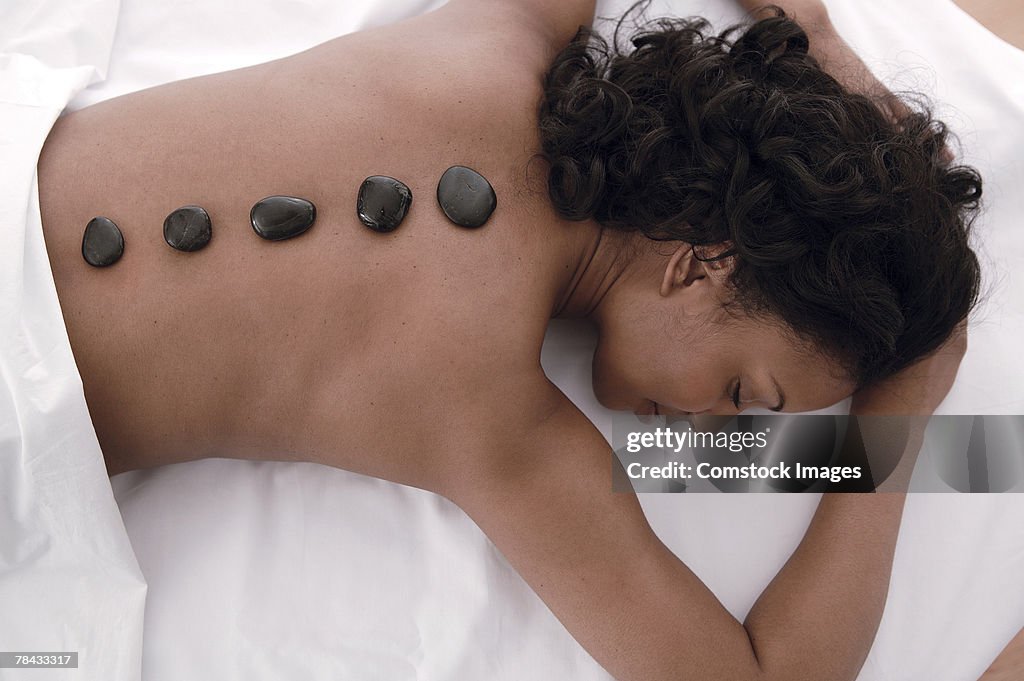 Woman at spa , hot stone massage