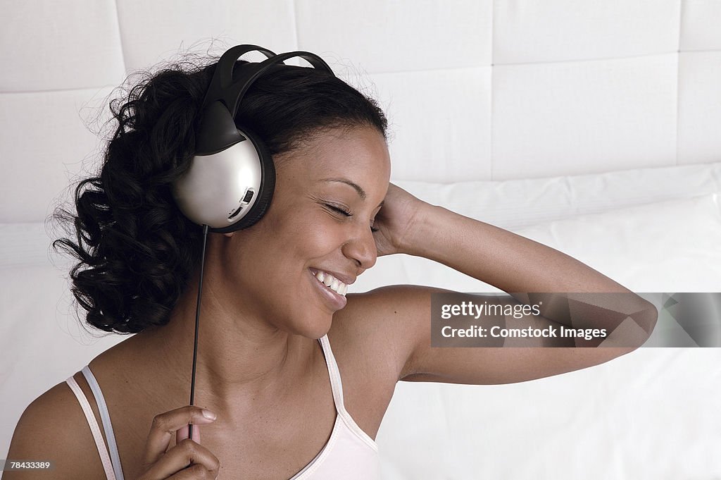 Woman listening to music through headphones