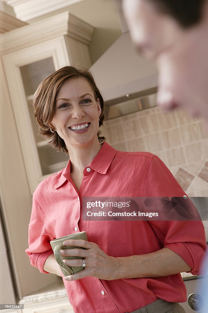 Woman drinking coffee in kitchen