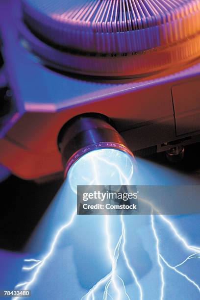 composite of lightning bolt coming from slide projector - slide projector stock pictures, royalty-free photos & images
