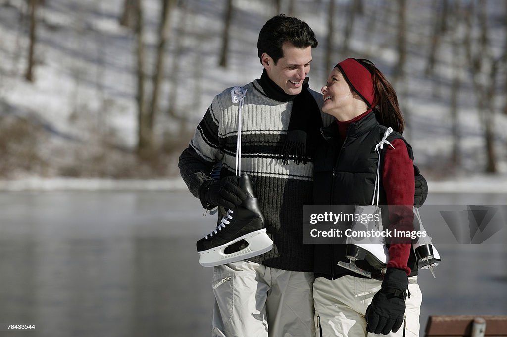 Couple carrying ice skates