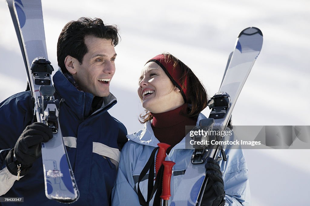 Couple carrying skis