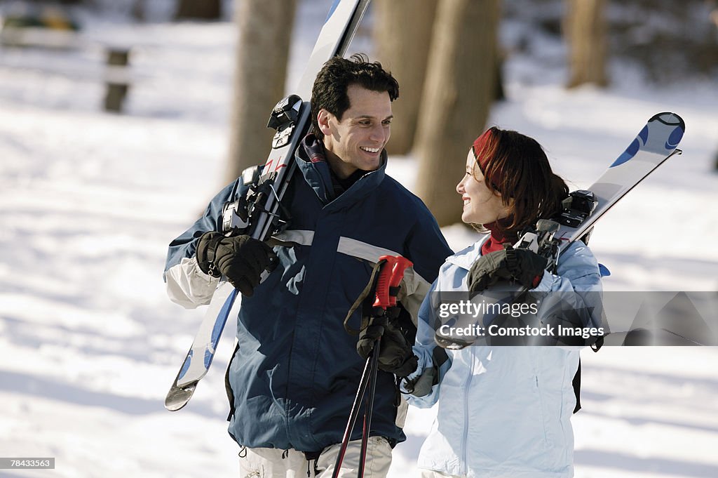 Couple carrying skis
