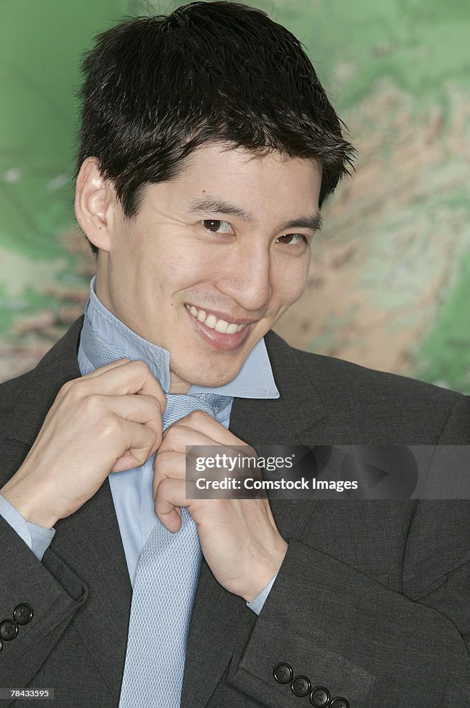 Businessman adjusting tie