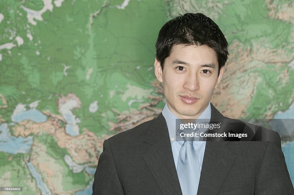 Businessman in front of world map