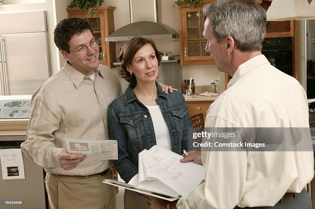 Couple with salesman in home improvement store
