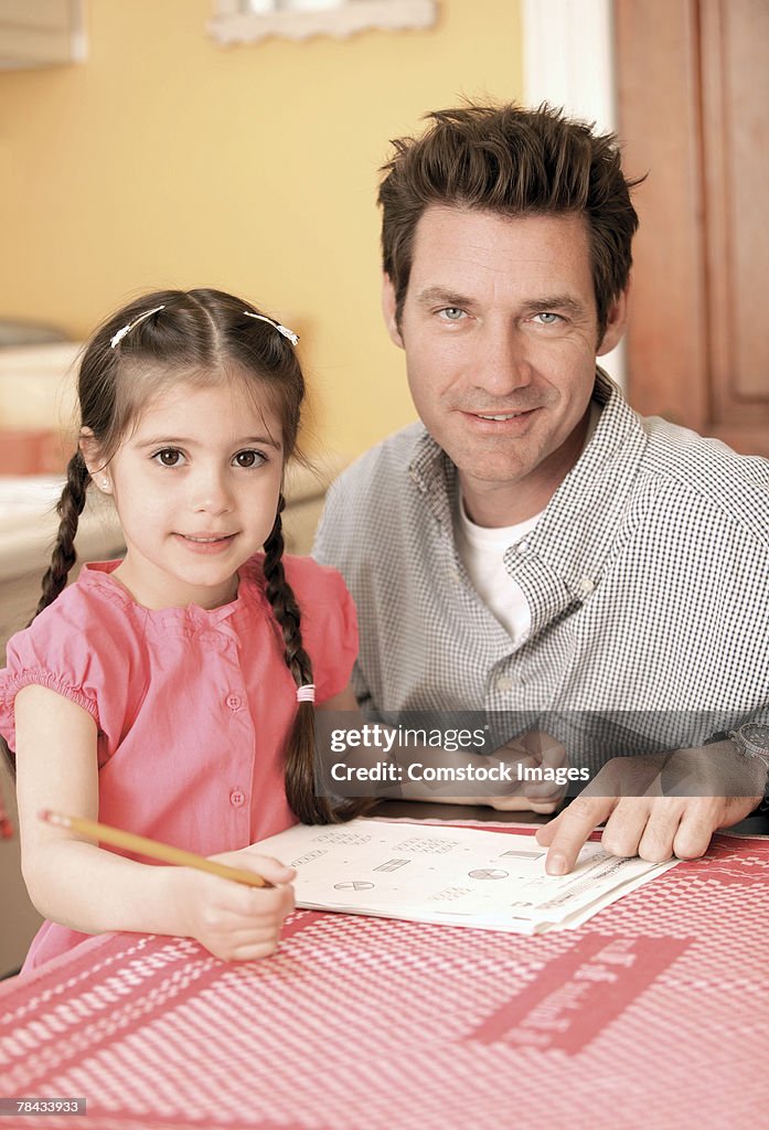 Father helping daughter with homework