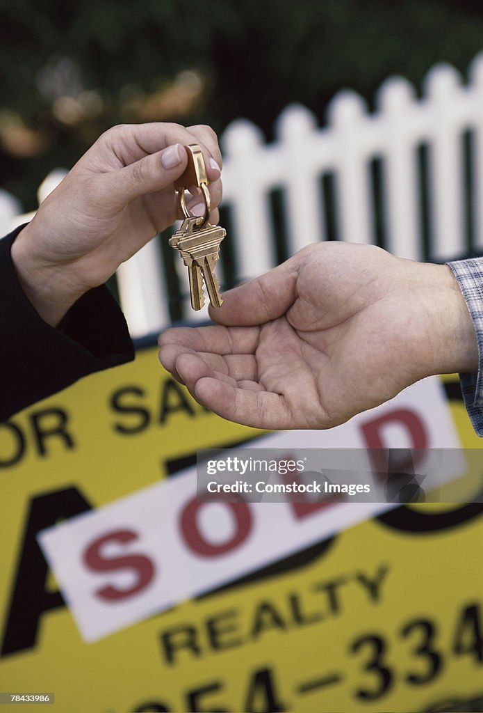 Realtor handing house keys to new owner