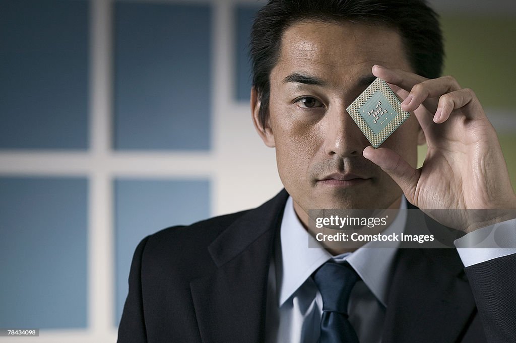 Businessman holding computer chip