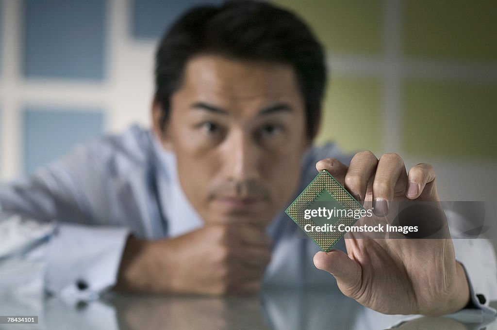 Businessman holding computer chip