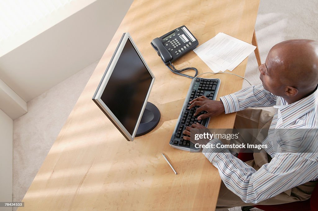 Businessman working on desktop computer in office