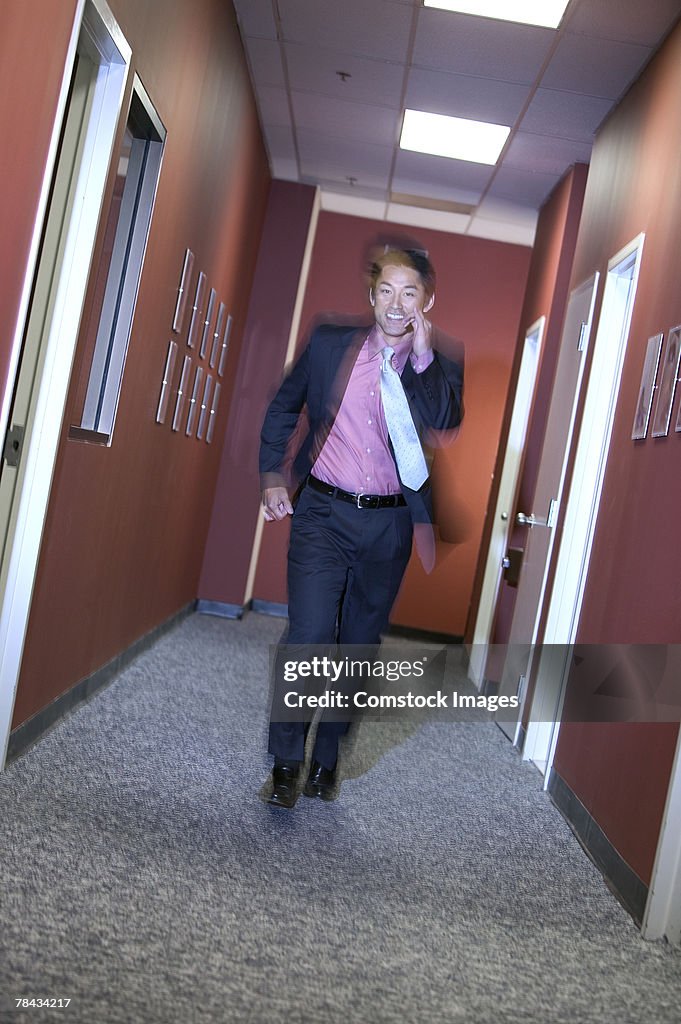 Businessman running in hallway