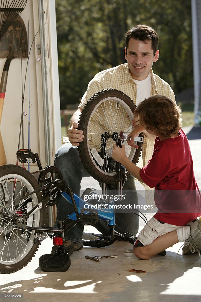 Father and son fixing bicycle