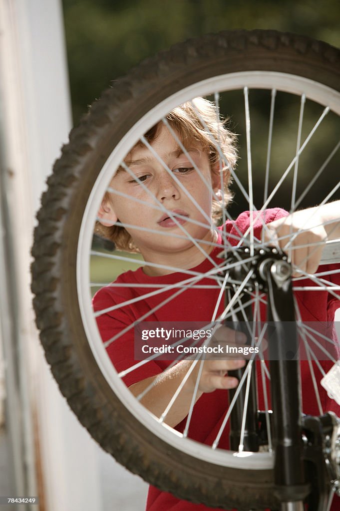 Boy fixing bicycle