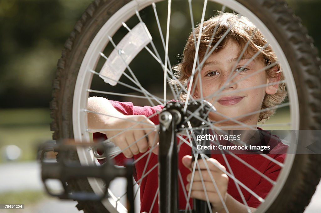 Boy fixing bicycle