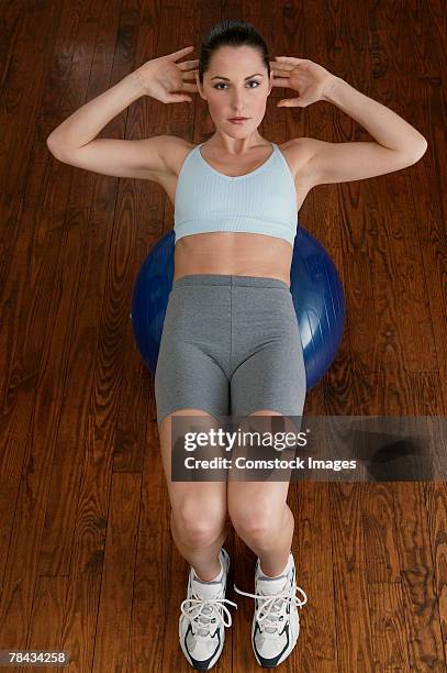 woman exercising with fitness ball - fitness ball stock pictures, royalty-free photos & images