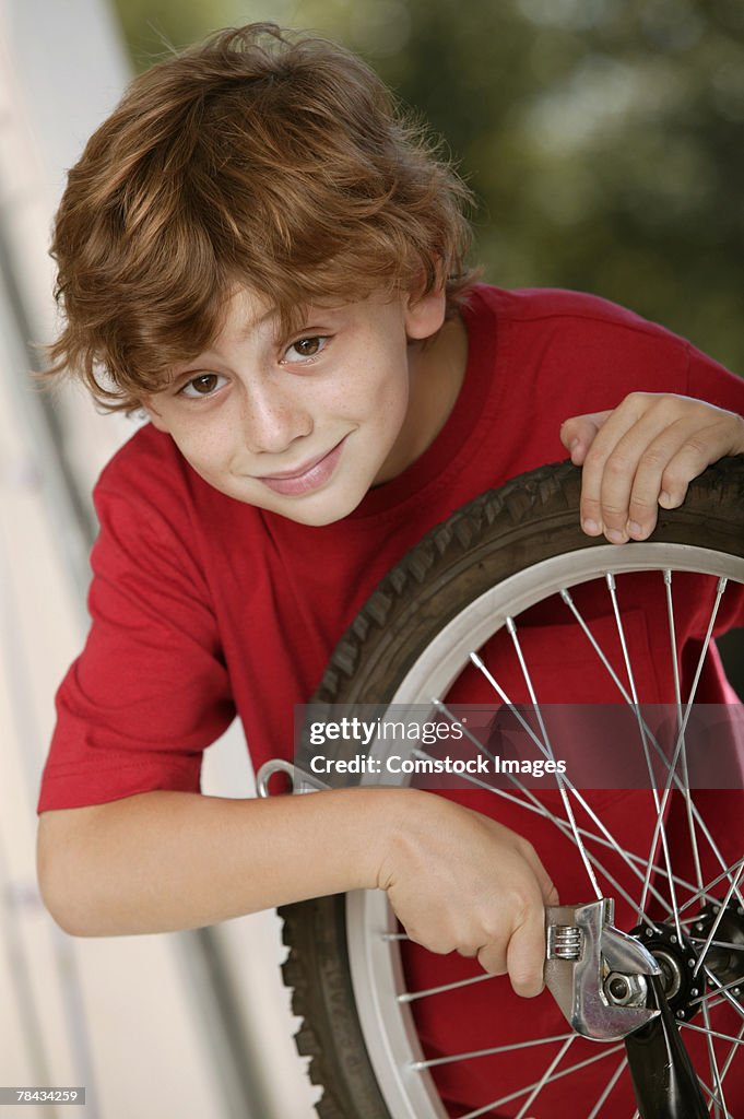 Boy fixing bicycle