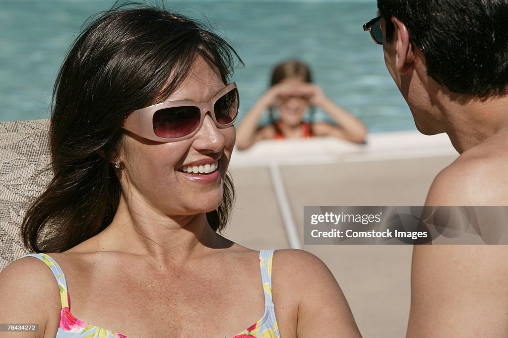 Man and woman talking at pool