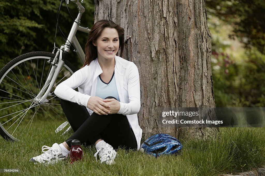 Woman resting near bicycle