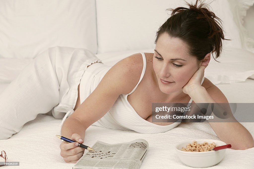 Woman relaxing with crossword puzzle