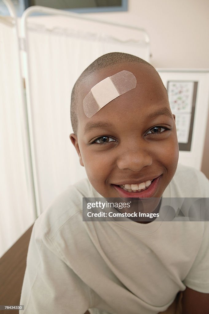 Boy with adhesive bandage on head