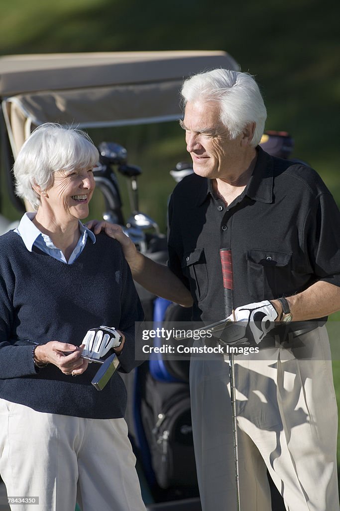Couple with golf clubs