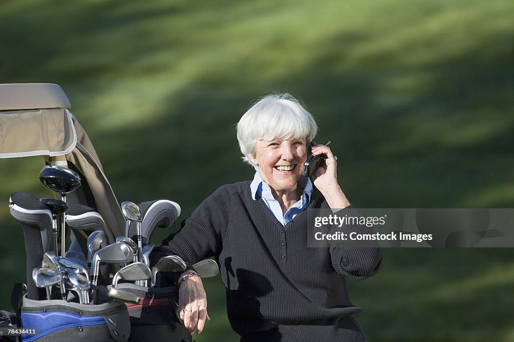 Woman golfer on cell phone