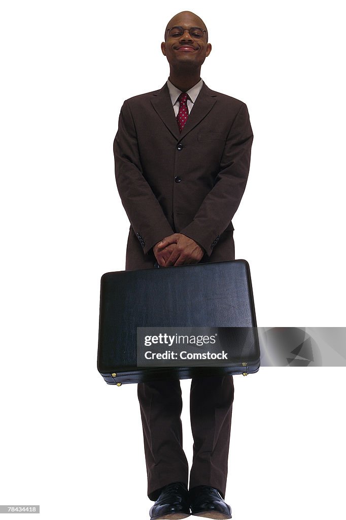 Businessman posing with briefcase