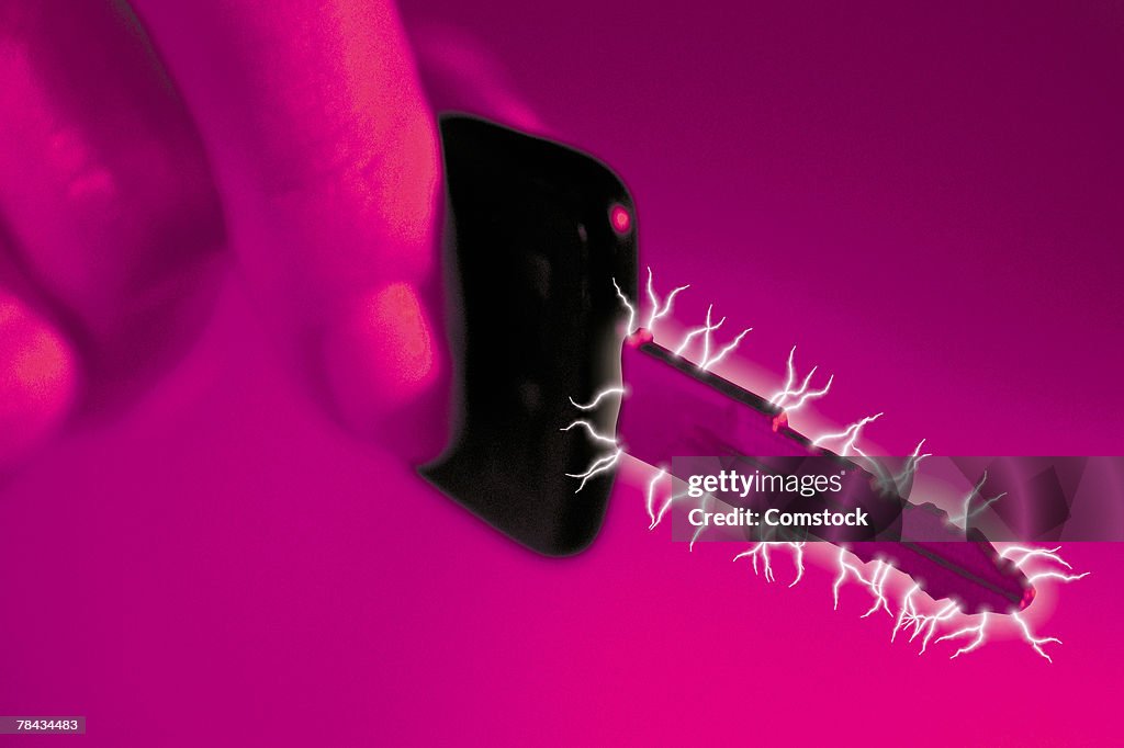 Composite of car key in hand and sparks