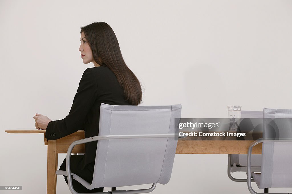 Businesswoman sitting at conference table