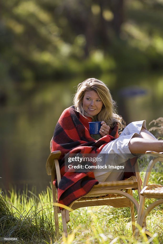 Woman with relaxing outdoors with coffee