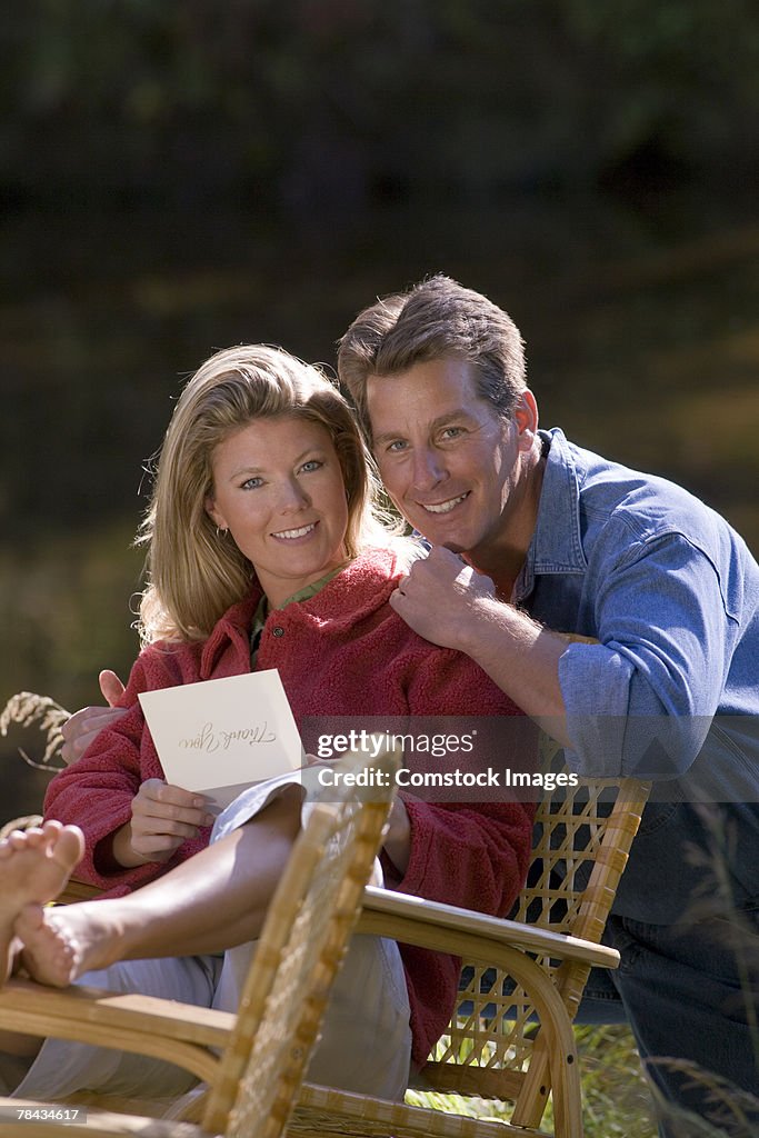 Couple with letter outdoors