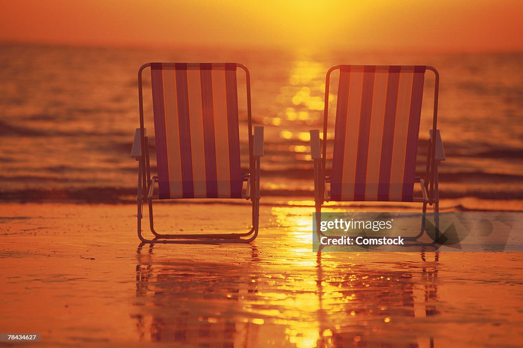 Beach chairs on the beach at sunset